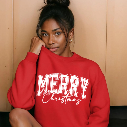 Woman wearing a red 'Merry Christmas' sweatshirt against a beige wall.